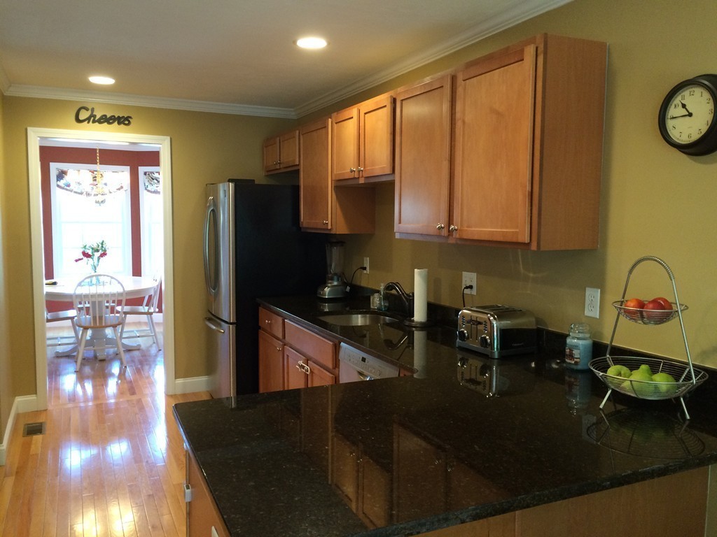 22 Whispering Pine Circle, Unit 29 Worcester, MA 01606 - Photo 6 of 30 a kitchen with a refrigerator and a stove top oven
