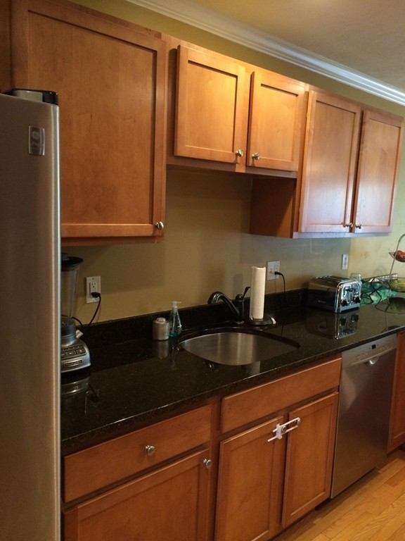 22 Whispering Pine Circle, Unit 29 Worcester, MA 01606 - Photo 8 of 30 a kitchen with granite countertop a sink cabinets and window