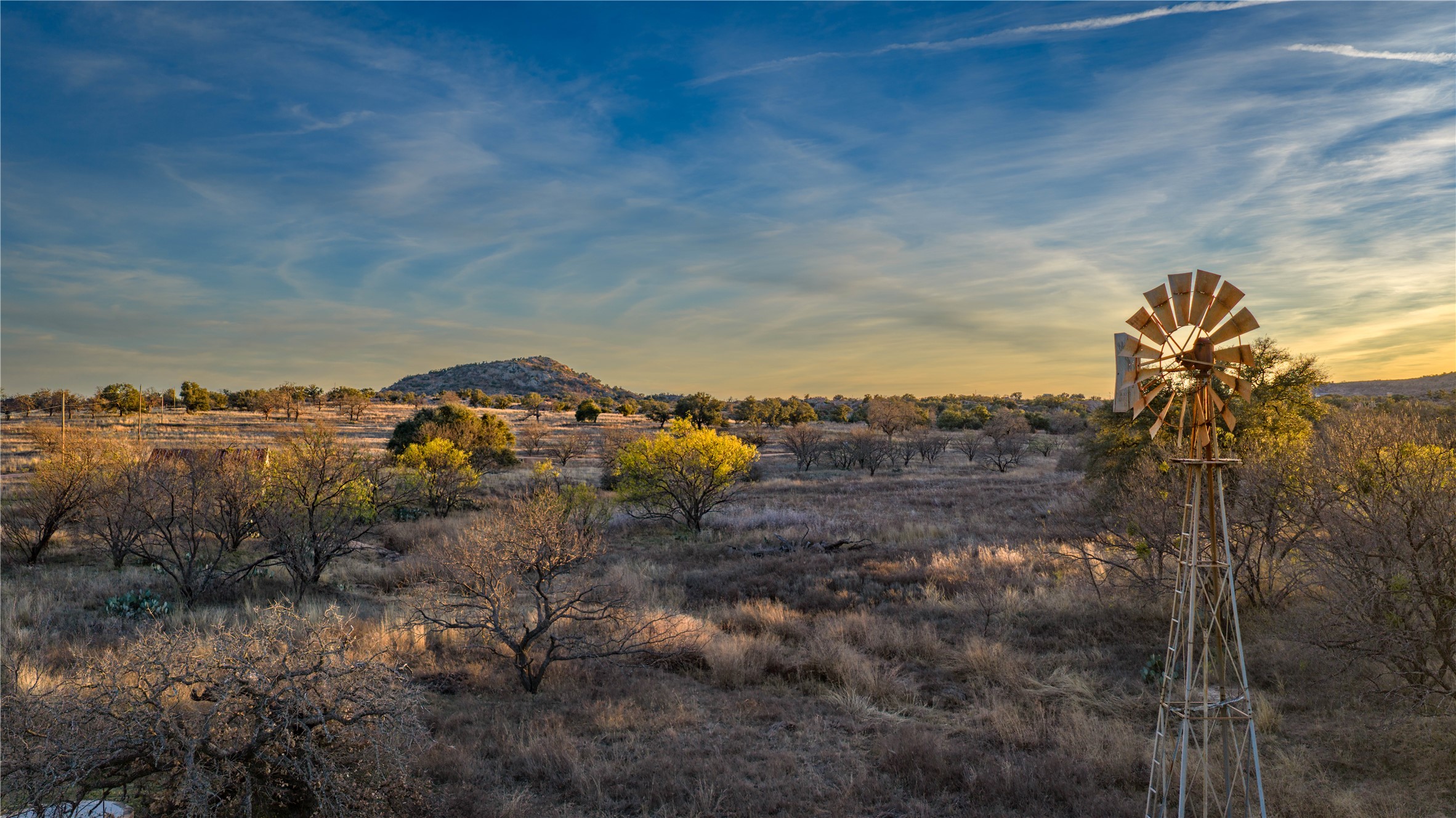 View of mountain backdrop with rural landscape