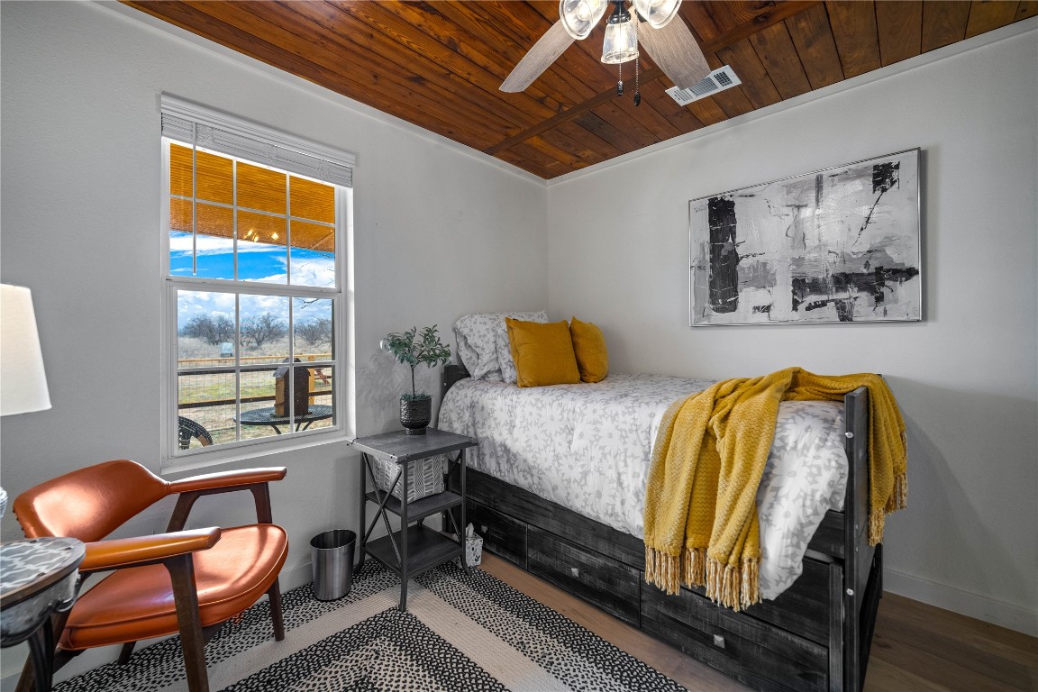 126 Buffalo Rd Valley Spring Valley Spring, TX 76885 - Photo 10 of 39 a bedroom with a bed and wooden floor