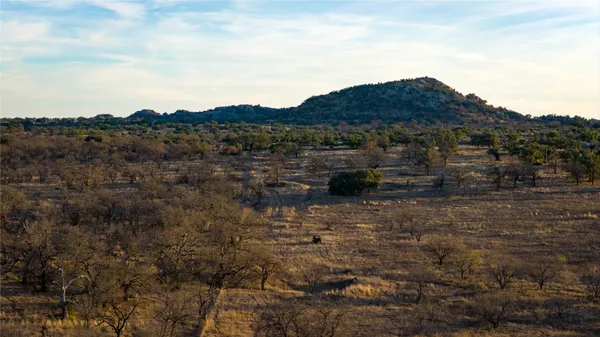 a view of a large mountain with a field