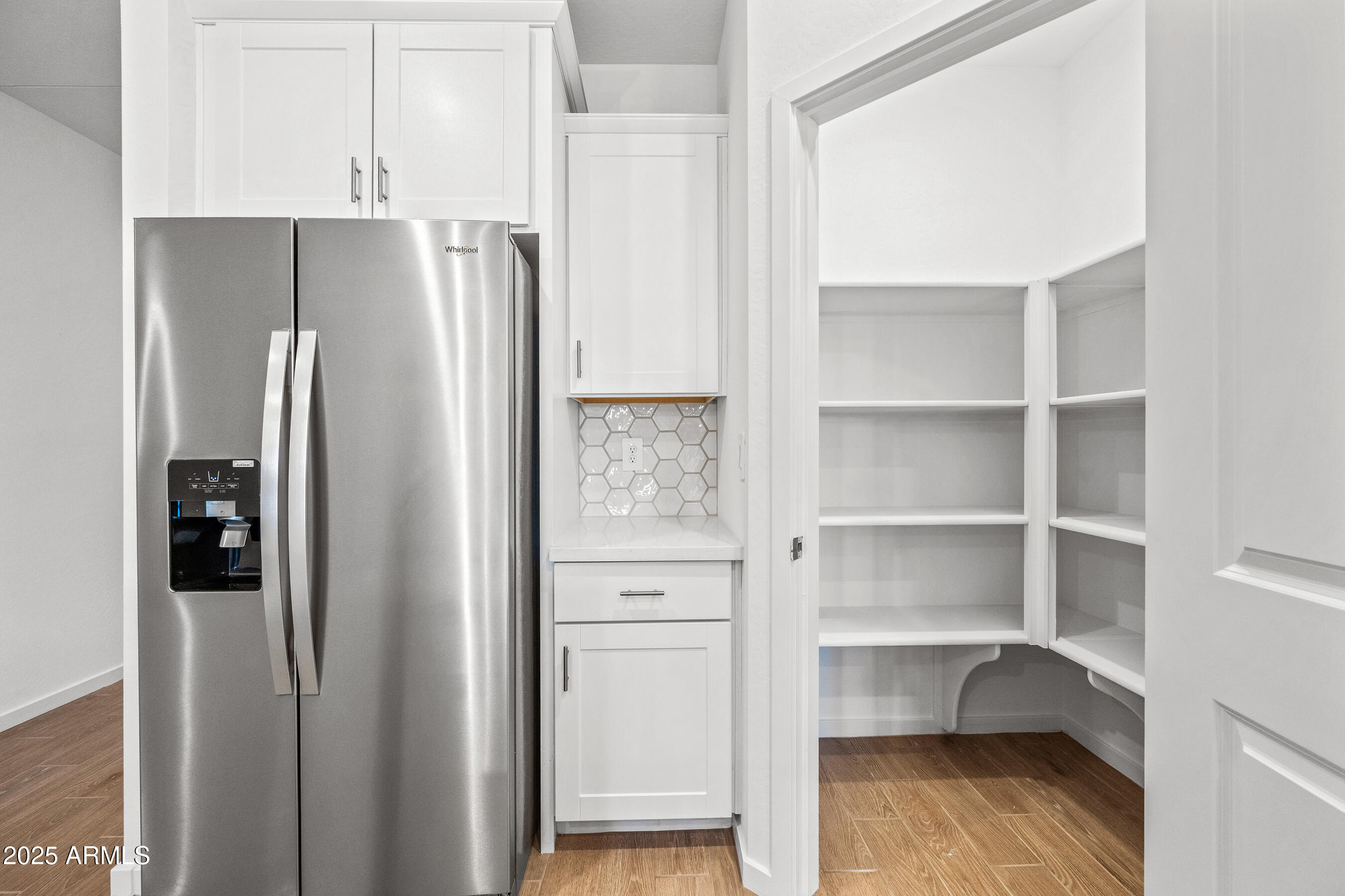 15825 West Gray Fox Trail Surprise, AZ 85387 - Photo 11 of 38 a view of walk in closet with empty racks