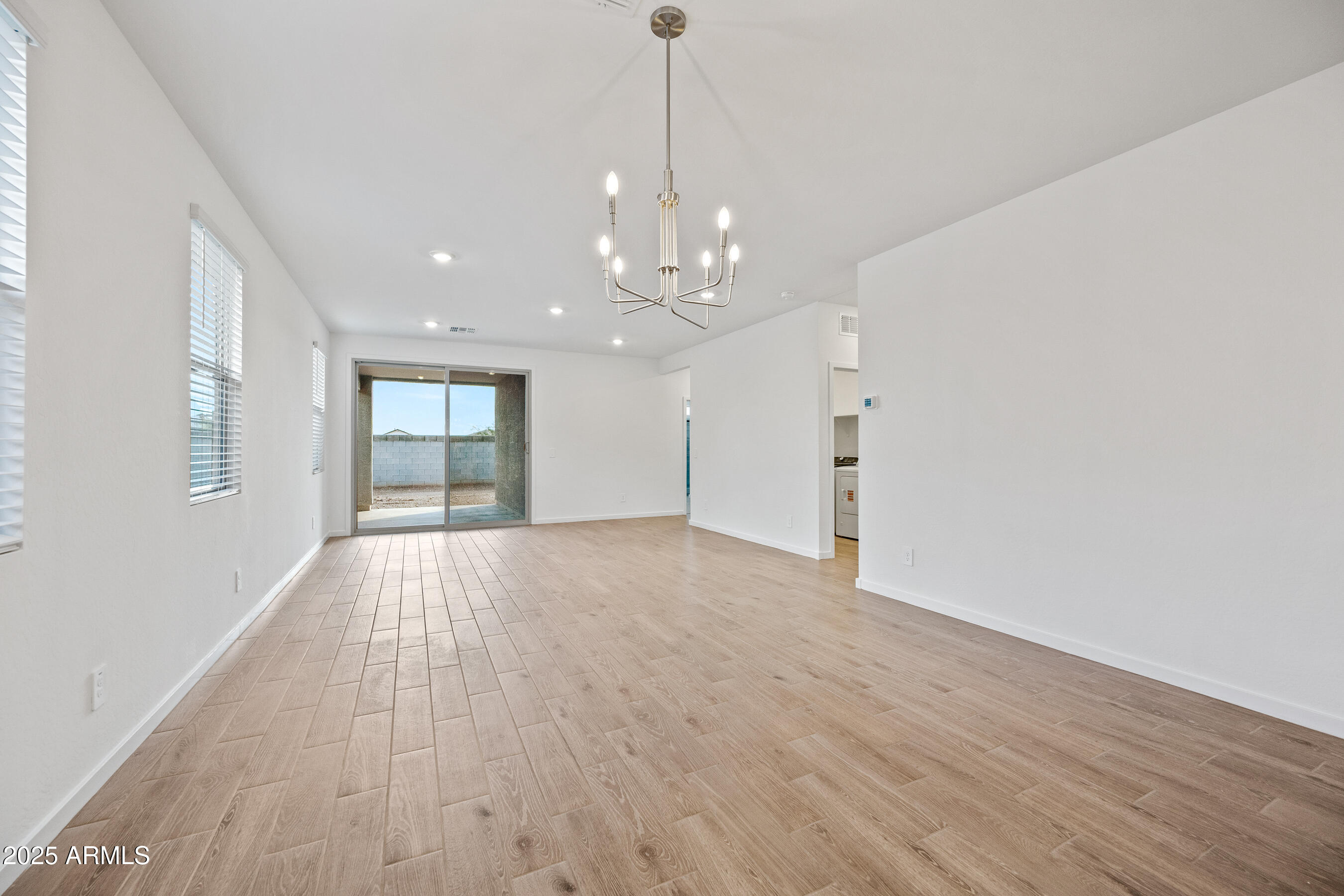15825 West Gray Fox Trail Surprise, AZ 85387 - Photo 12 of 38 a view of an empty room with window and wooden floor