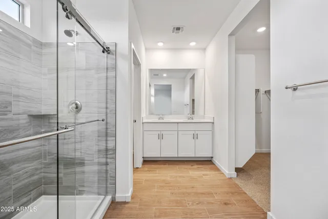 a bathroom with a shower and a sink