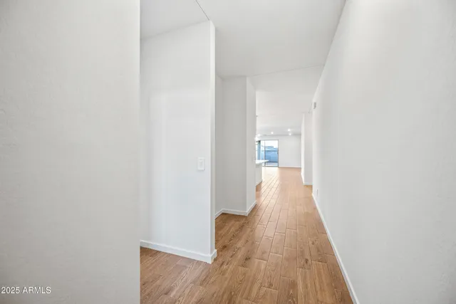 a view of a room with wooden floor