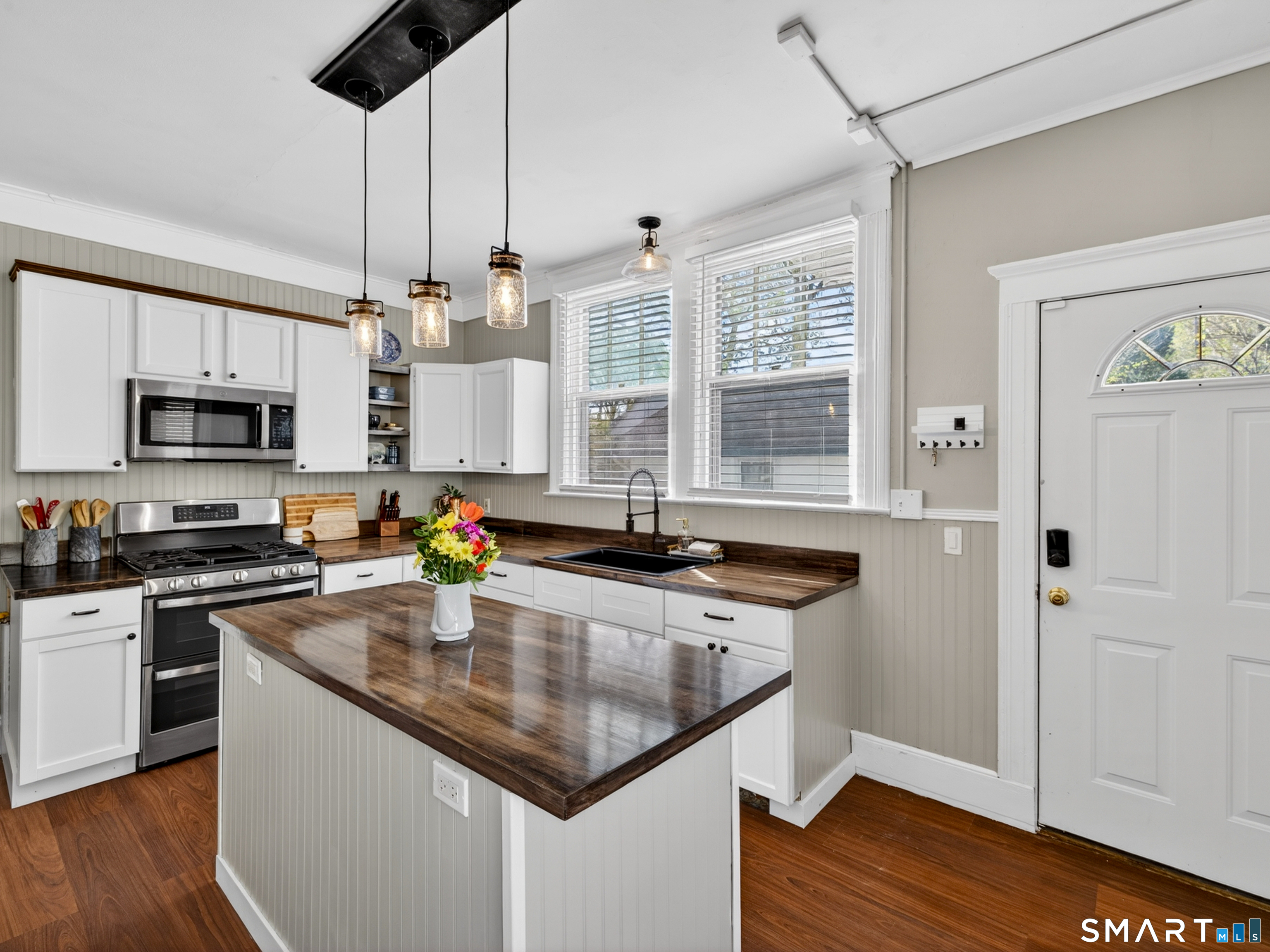 115 West Thames Street Norwich, CT 06360 - Photo 16 of 40 a kitchen with stainless steel appliances granite countertop a sink a stove and a wooden floors