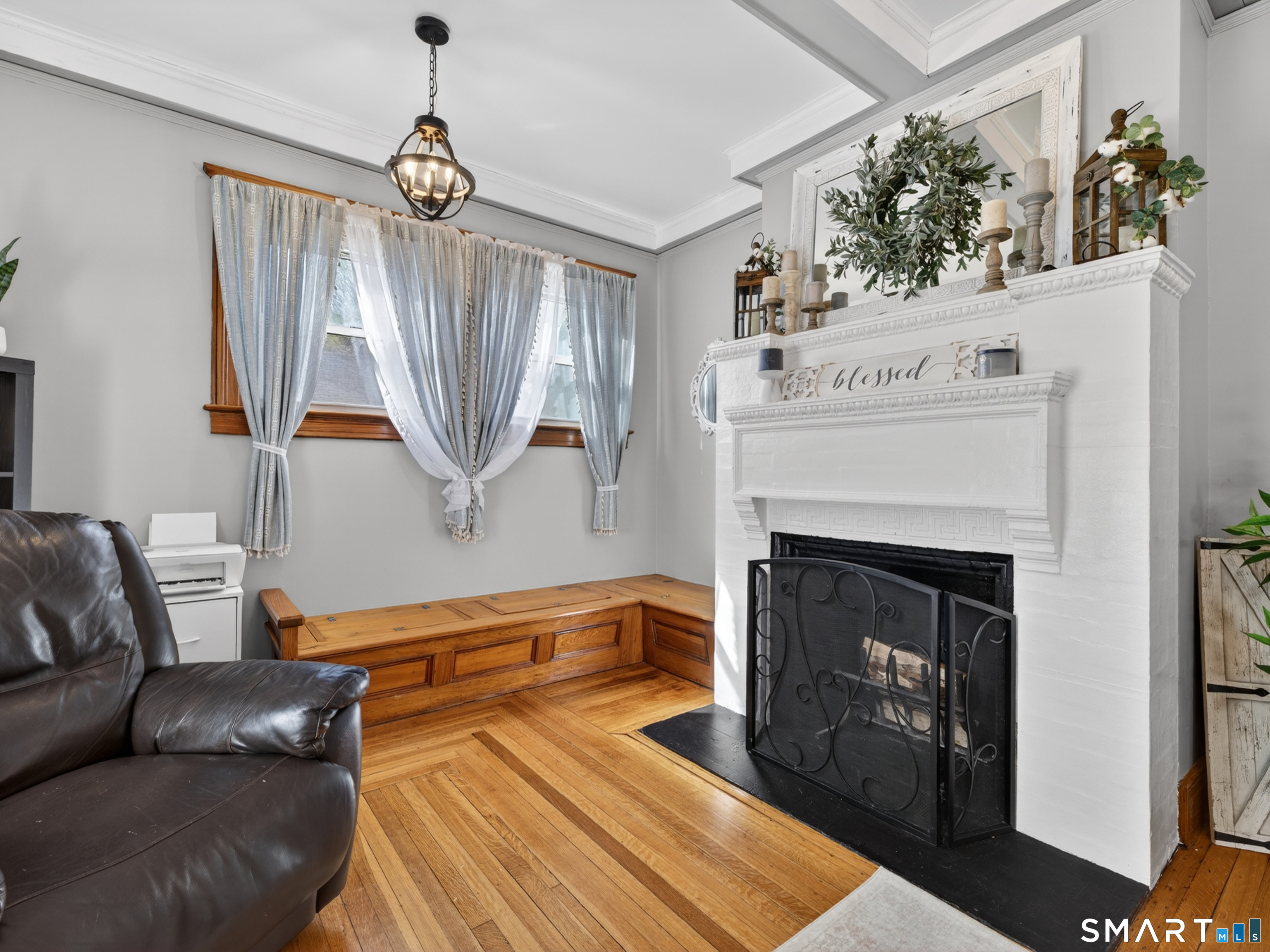 115 West Thames Street Norwich, CT 06360 - Photo 23 of 40 a living room with furniture a fireplace and a chandelier