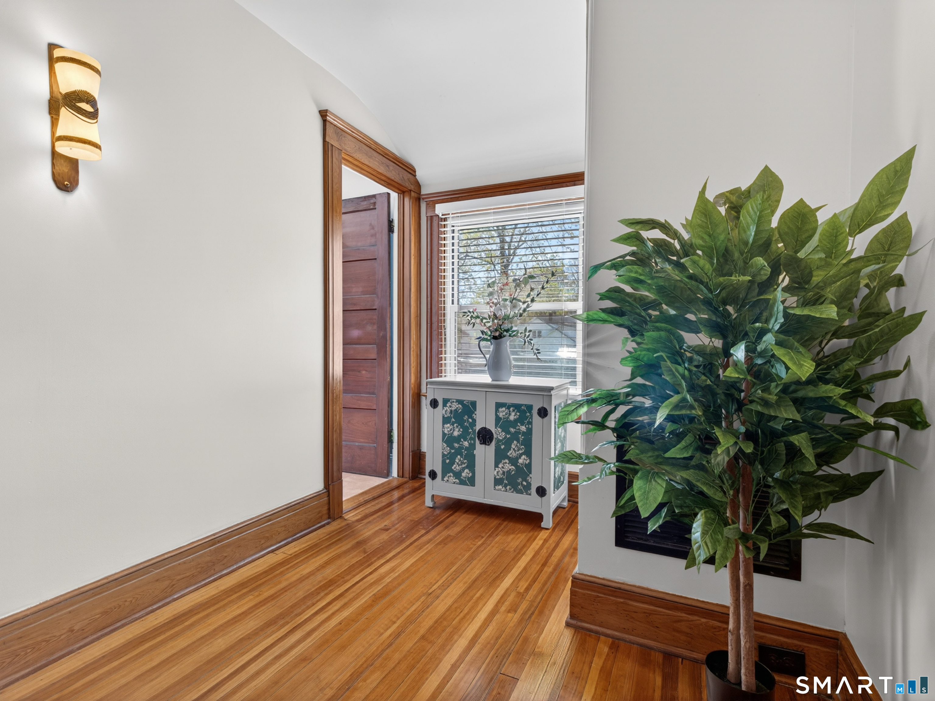 115 West Thames Street Norwich, CT 06360 - Photo 25 of 40 a room with wooden floor and a potted plant