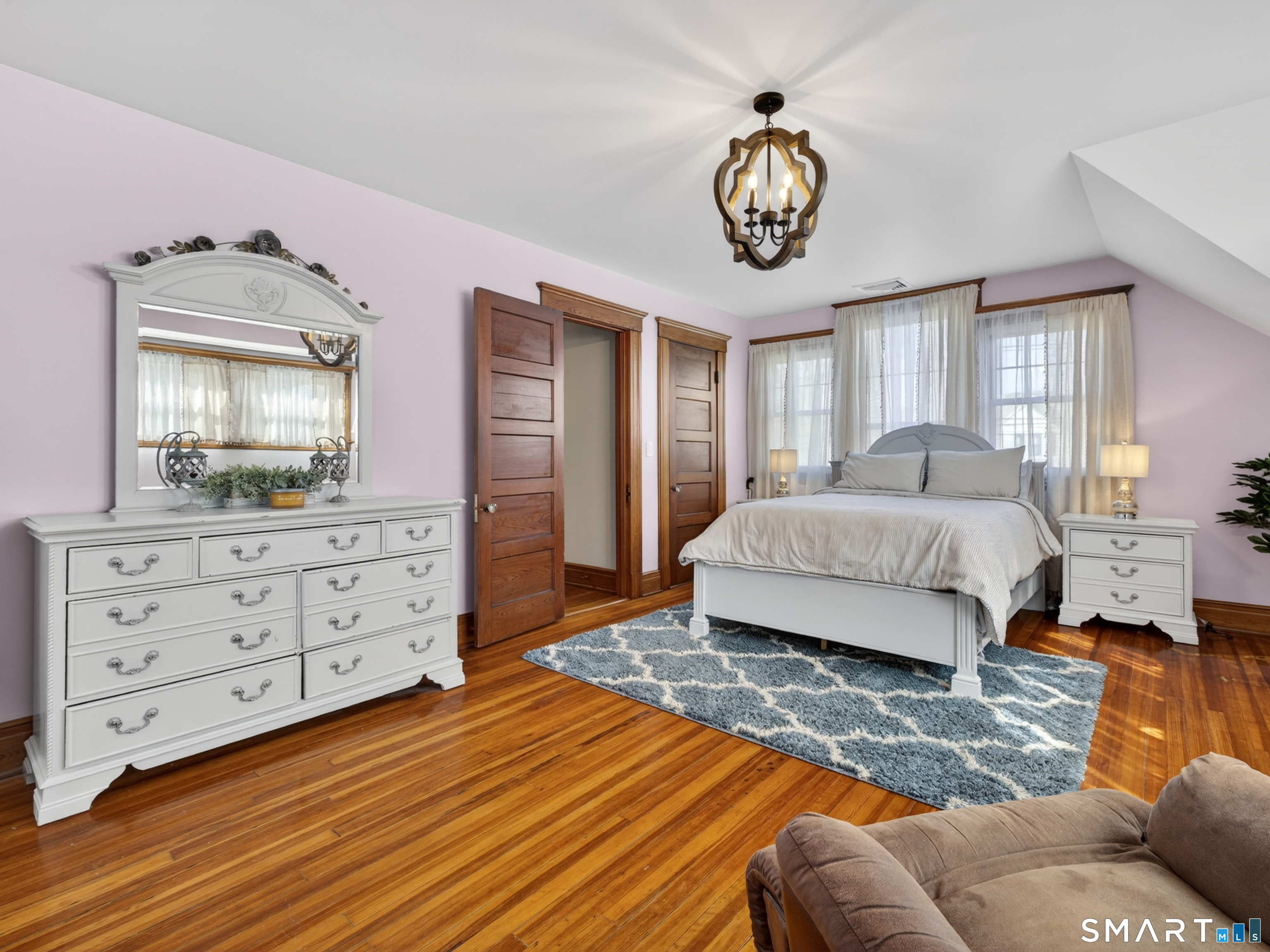 115 West Thames Street Norwich, CT 06360 - Photo 28 of 40 a spacious bedroom with a bed a dresser and windows