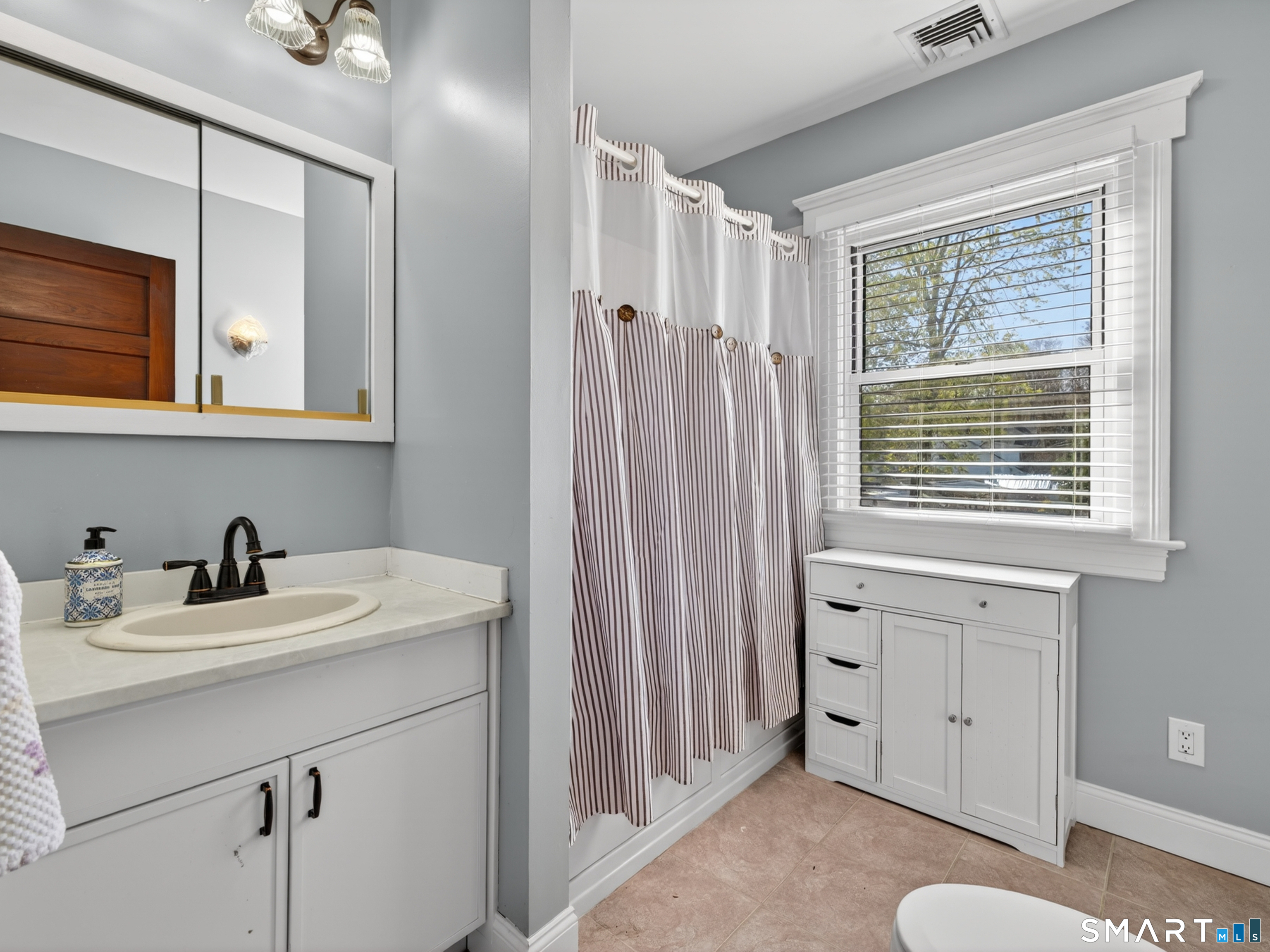 115 West Thames Street Norwich, CT 06360 - Photo 30 of 40 a bathroom with a sink a vanity and a mirror