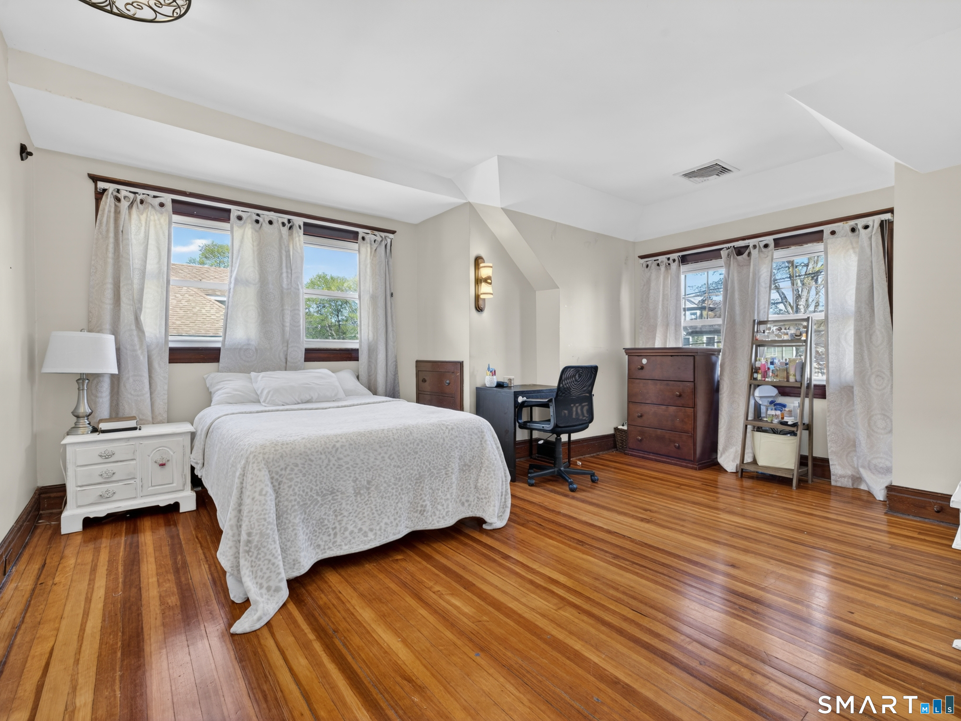 115 West Thames Street Norwich, CT 06360 - Photo 31 of 40 a spacious bedroom with a bed and wooden floor