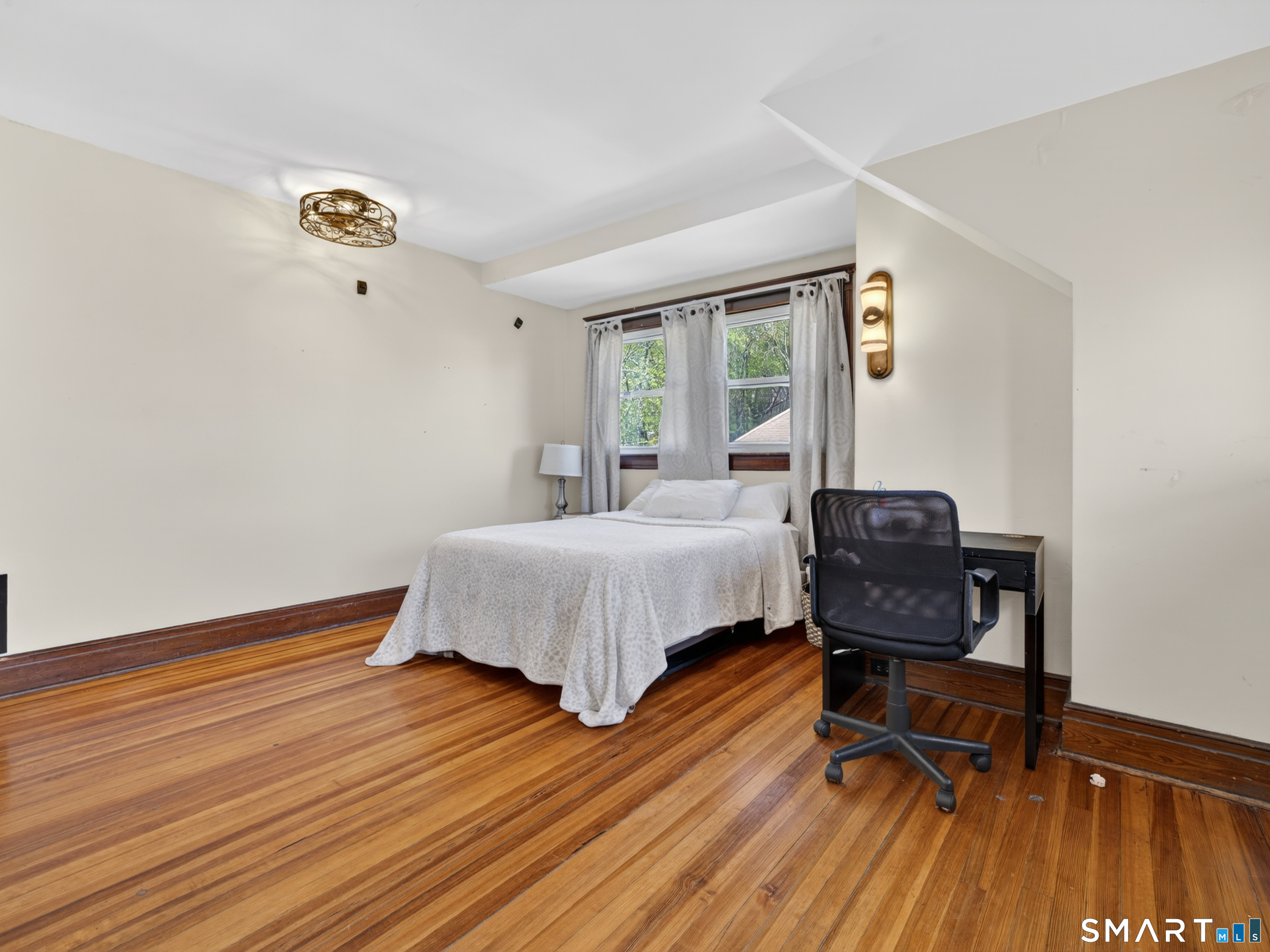 115 West Thames Street Norwich, CT 06360 - Photo 33 of 40 a bedroom with a bed and a mirror