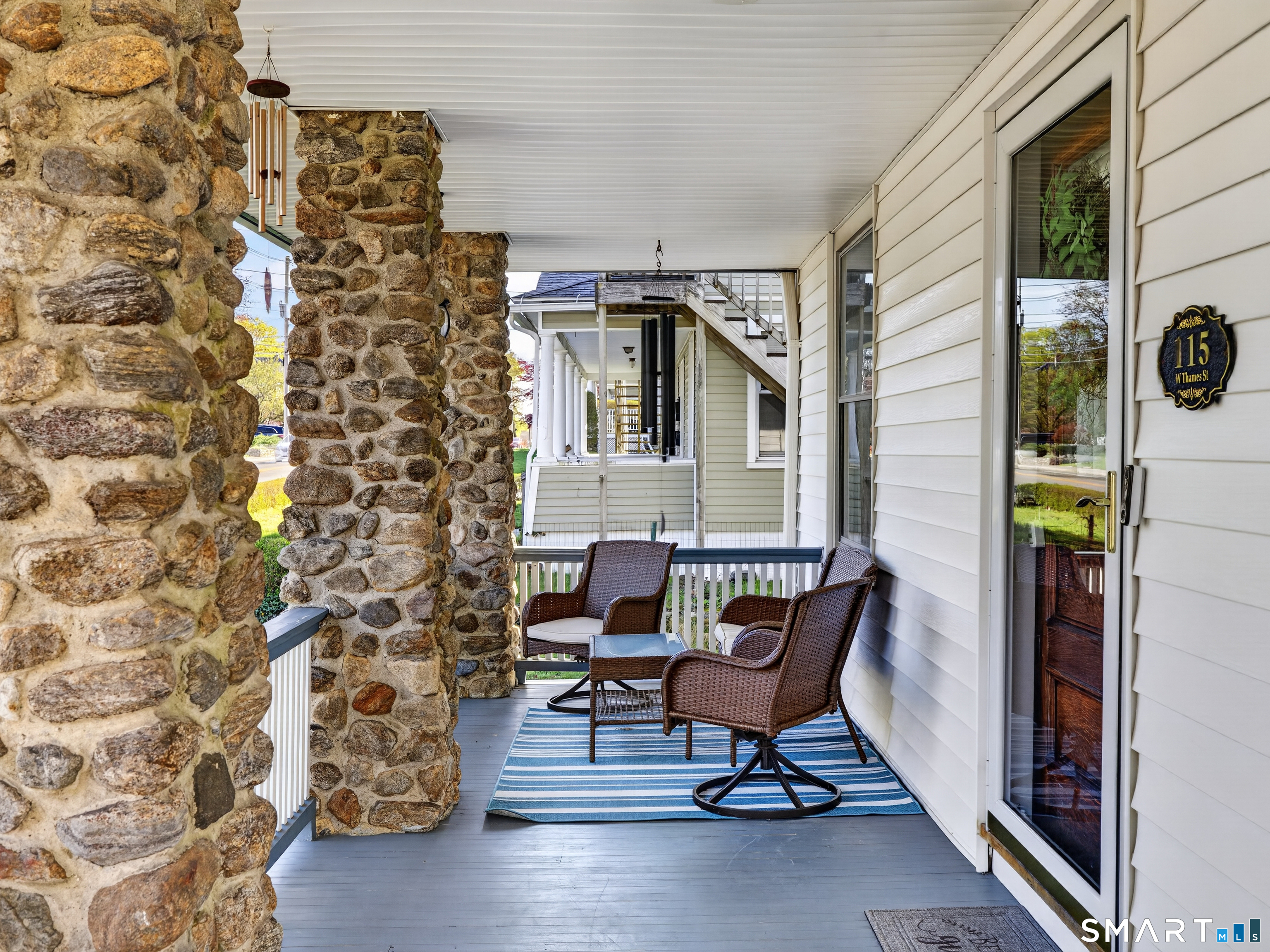 115 West Thames Street Norwich, CT 06360 - Photo 5 of 40 a balcony with table and chairs