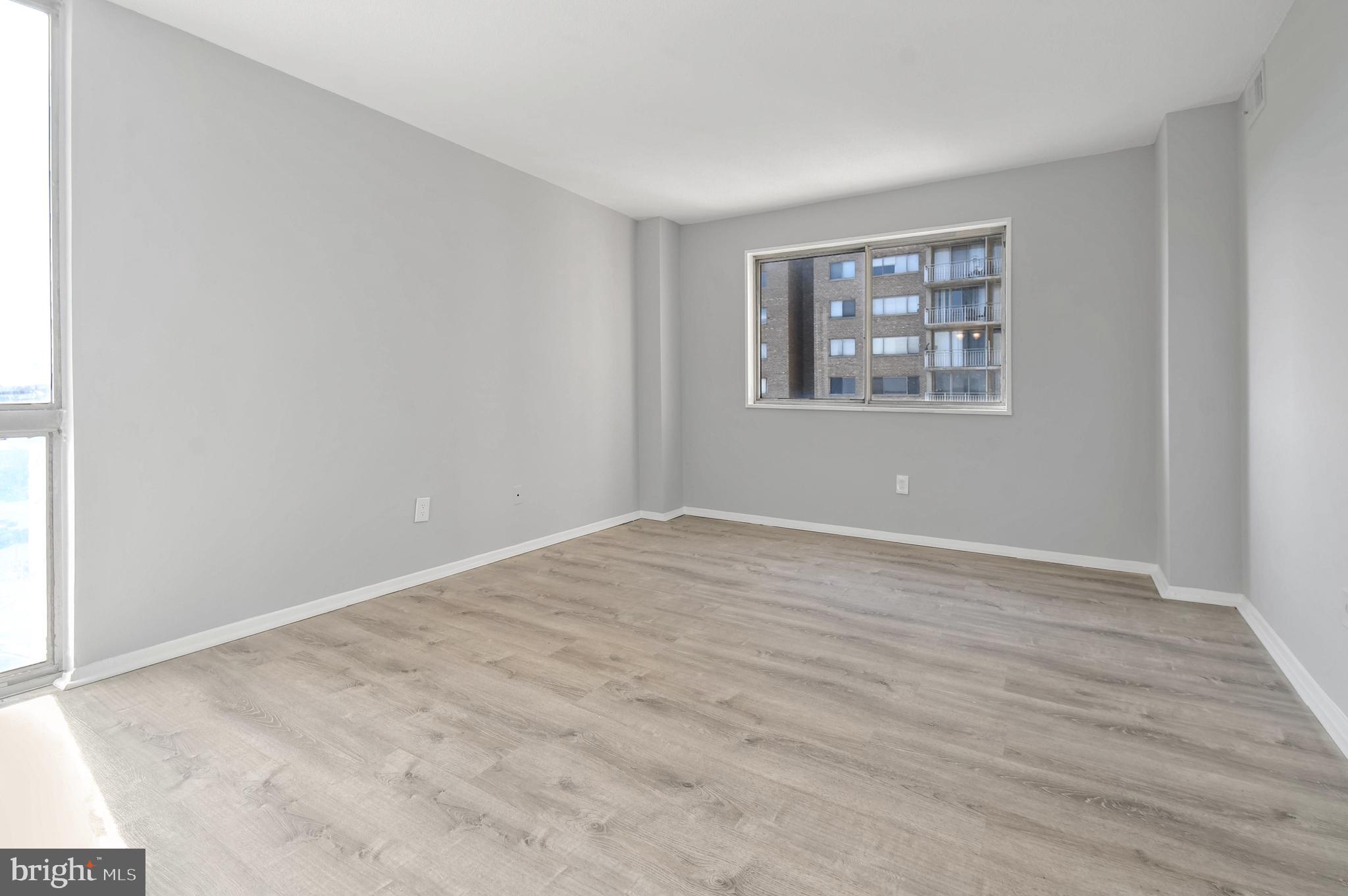 1836 Metzerott Road, Unit 925 Hyattsville, MD 20783 - Photo 11 of 33 a view of an empty room with wooden floor and a window