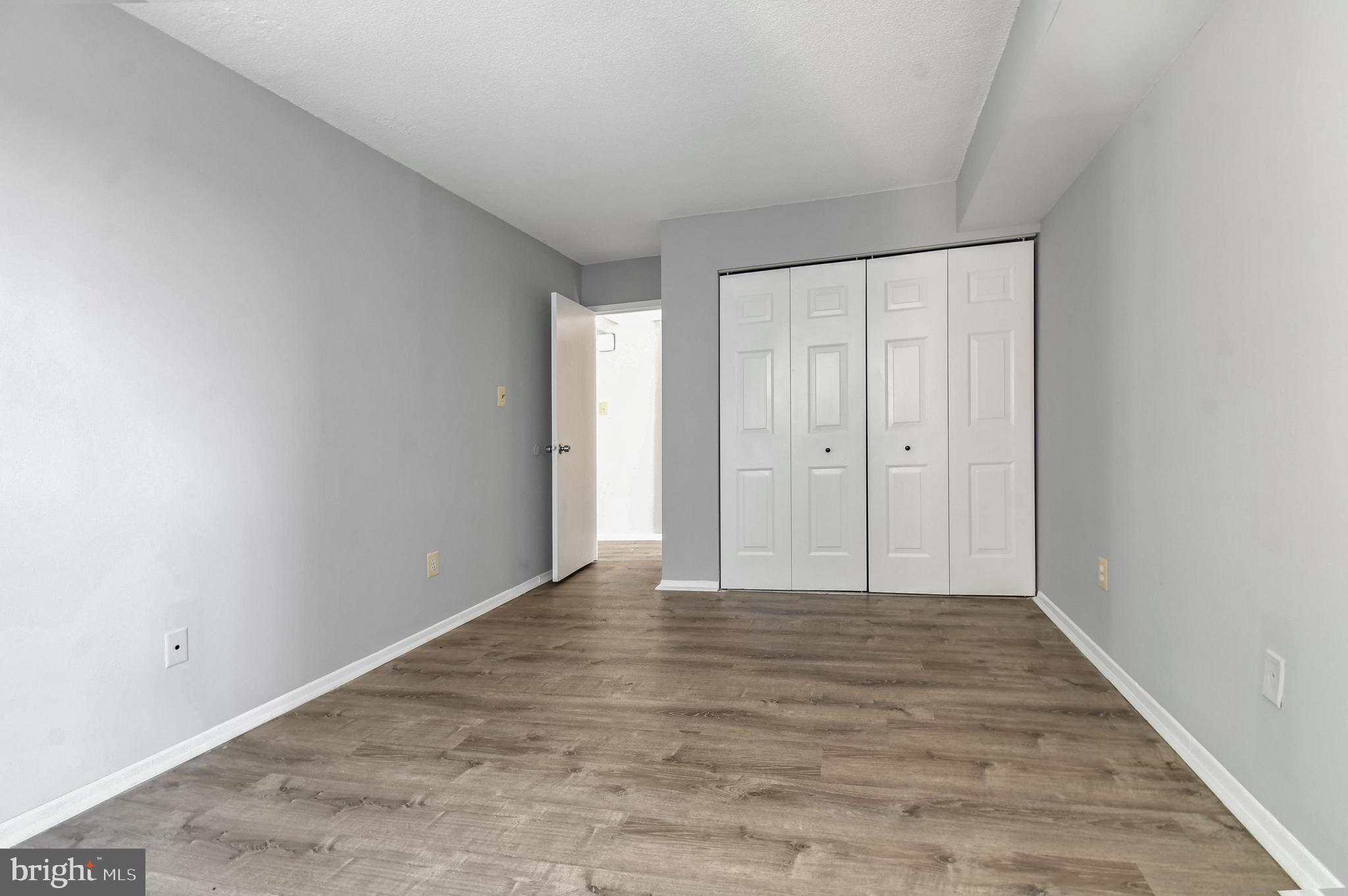 1836 Metzerott Road, Unit 925 Hyattsville, MD 20783 - Photo 13 of 33 a view of an empty room with wooden floor