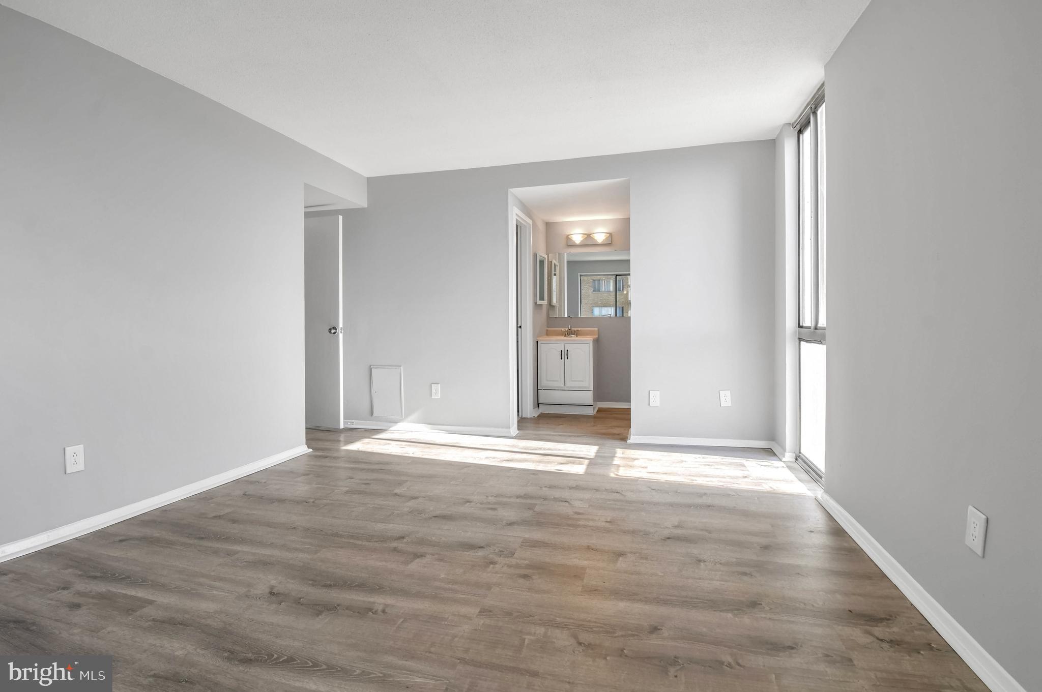 1836 Metzerott Road, Unit 925 Hyattsville, MD 20783 - Photo 16 of 33 an empty room with wooden floor and windows