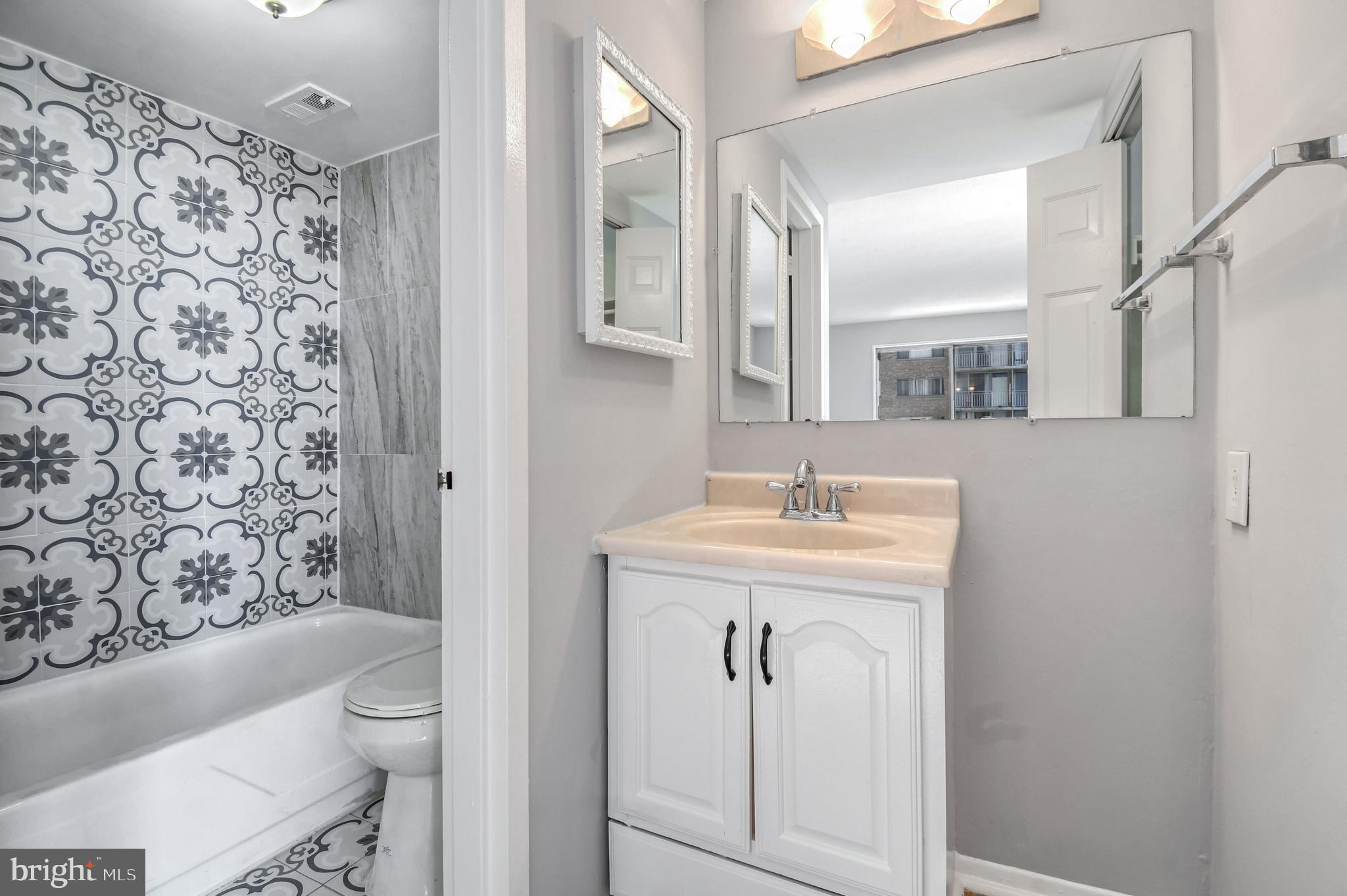 1836 Metzerott Road, Unit 925 Hyattsville, MD 20783 - Photo 18 of 33 a bathroom with a sink a toilet and shower