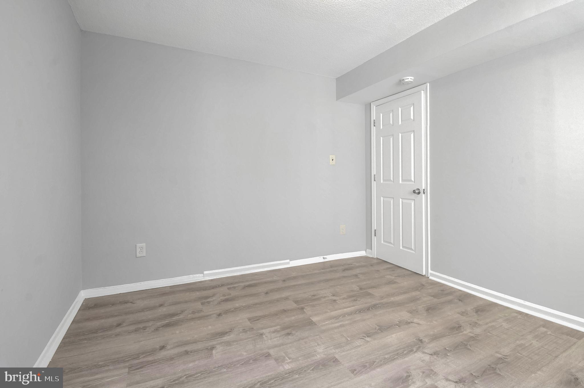1836 Metzerott Road, Unit 925 Hyattsville, MD 20783 - Photo 22 of 33 a view of an empty room with wooden floor