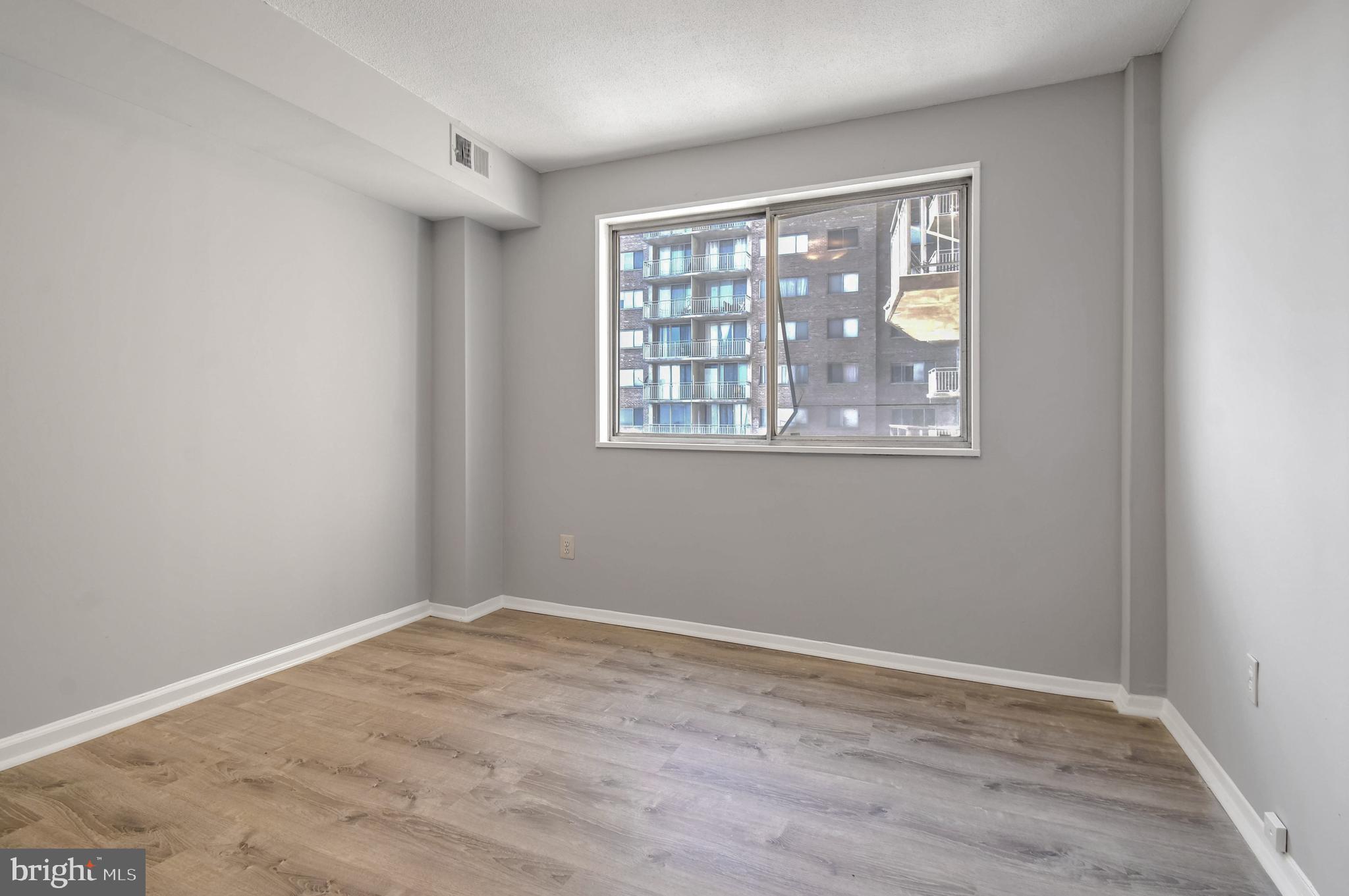 1836 Metzerott Road, Unit 925 Hyattsville, MD 20783 - Photo 23 of 33 a view of empty room with wooden floor and fan