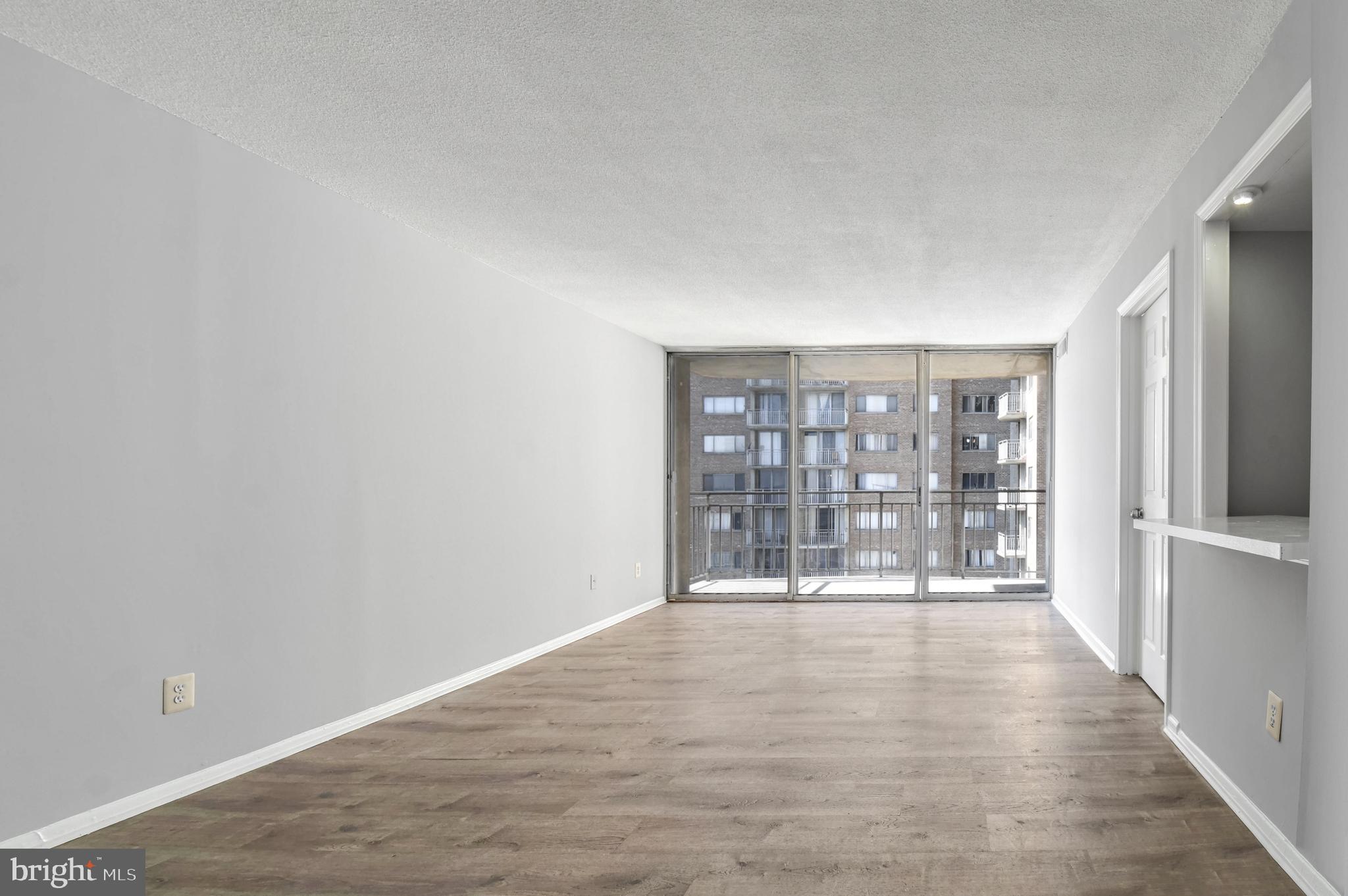 1836 Metzerott Road, Unit 925 Hyattsville, MD 20783 - Photo 5 of 33 a view of an empty room with wooden floor and a window