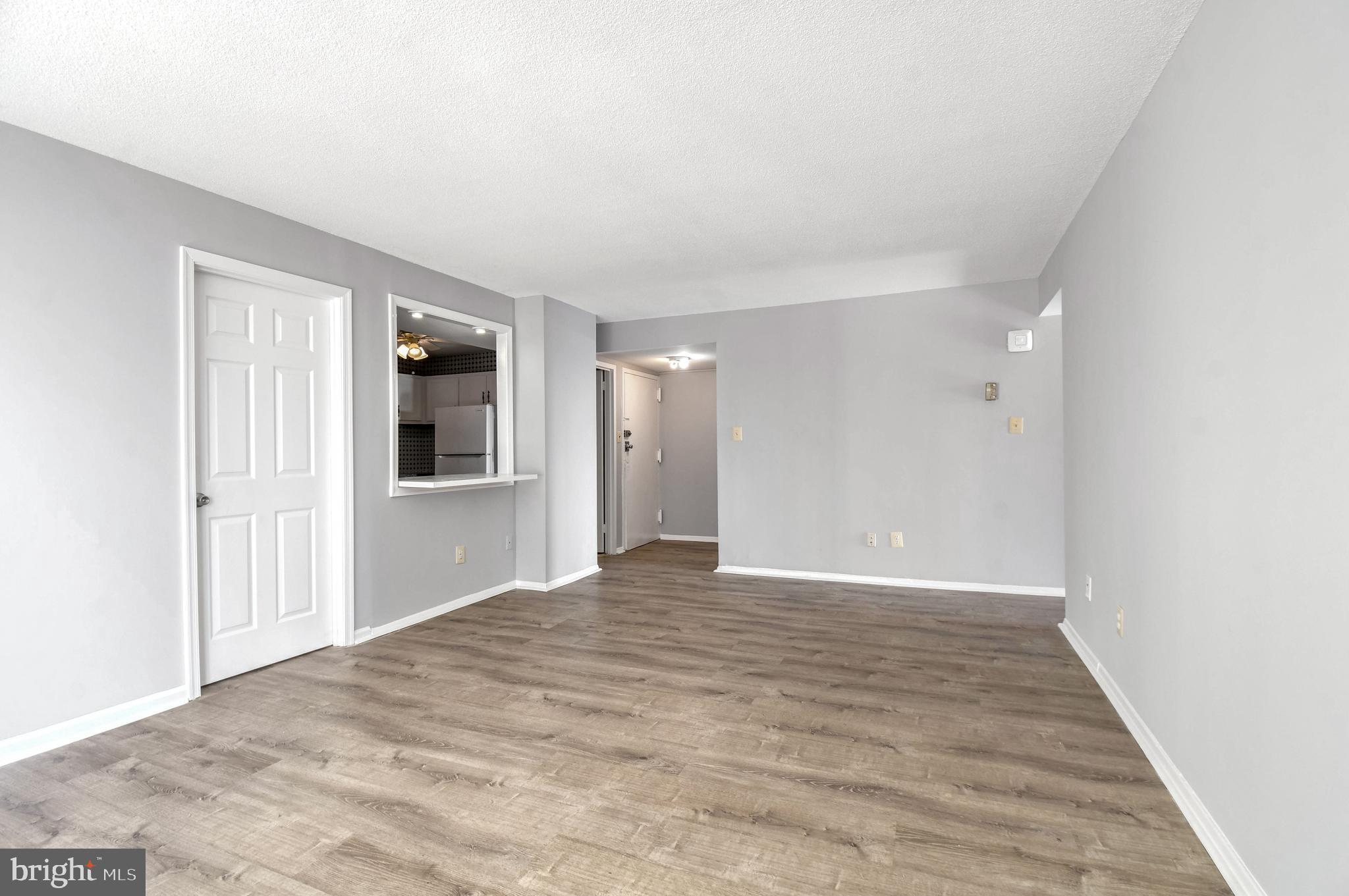 1836 Metzerott Road, Unit 925 Hyattsville, MD 20783 - Photo 7 of 33 a view of an empty room with wooden floor and a window