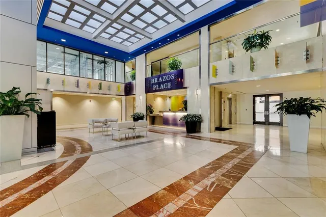 a lobby with furniture and a fireplace