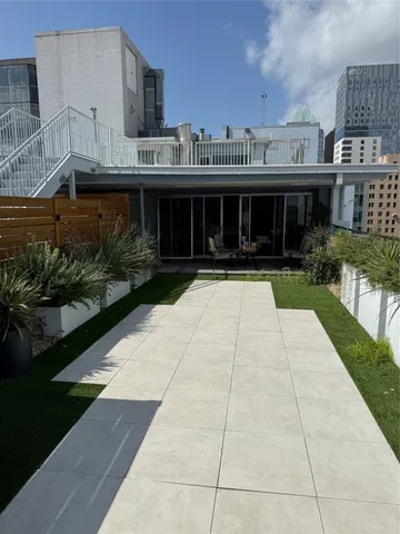 a view of a backyard with sitting area