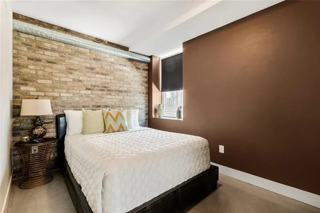 a kitchen with stainless steel appliances granite countertop a sink and a refrigerator