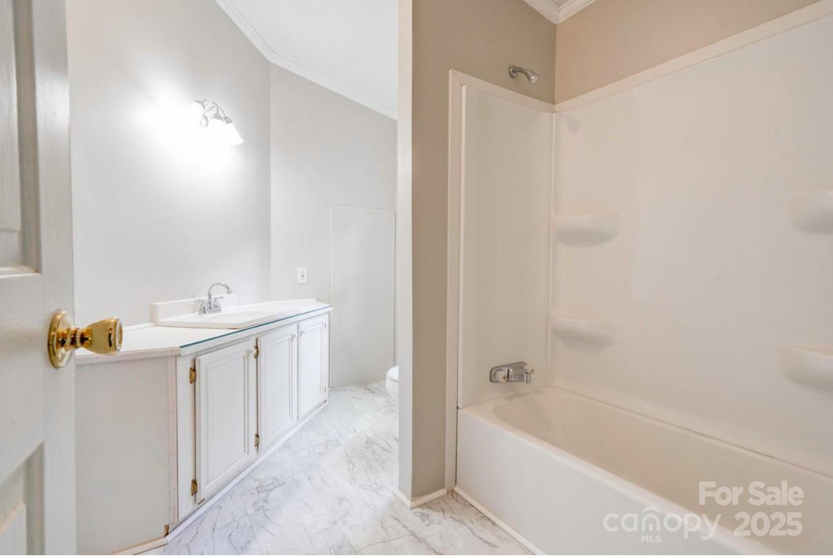2026 Rehobeth Church Road Shelby, NC 28150 - Photo 35 of 48 a bathroom with a bathtub a sink a mirror a vanity and shower