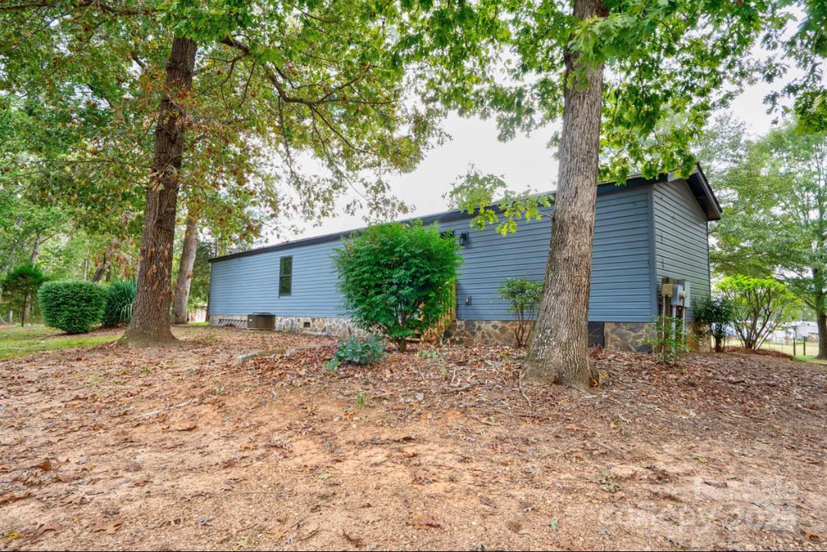 2026 Rehobeth Church Road Shelby, NC 28150 - Photo 6 of 48 a backyard of a house with plants and large tree