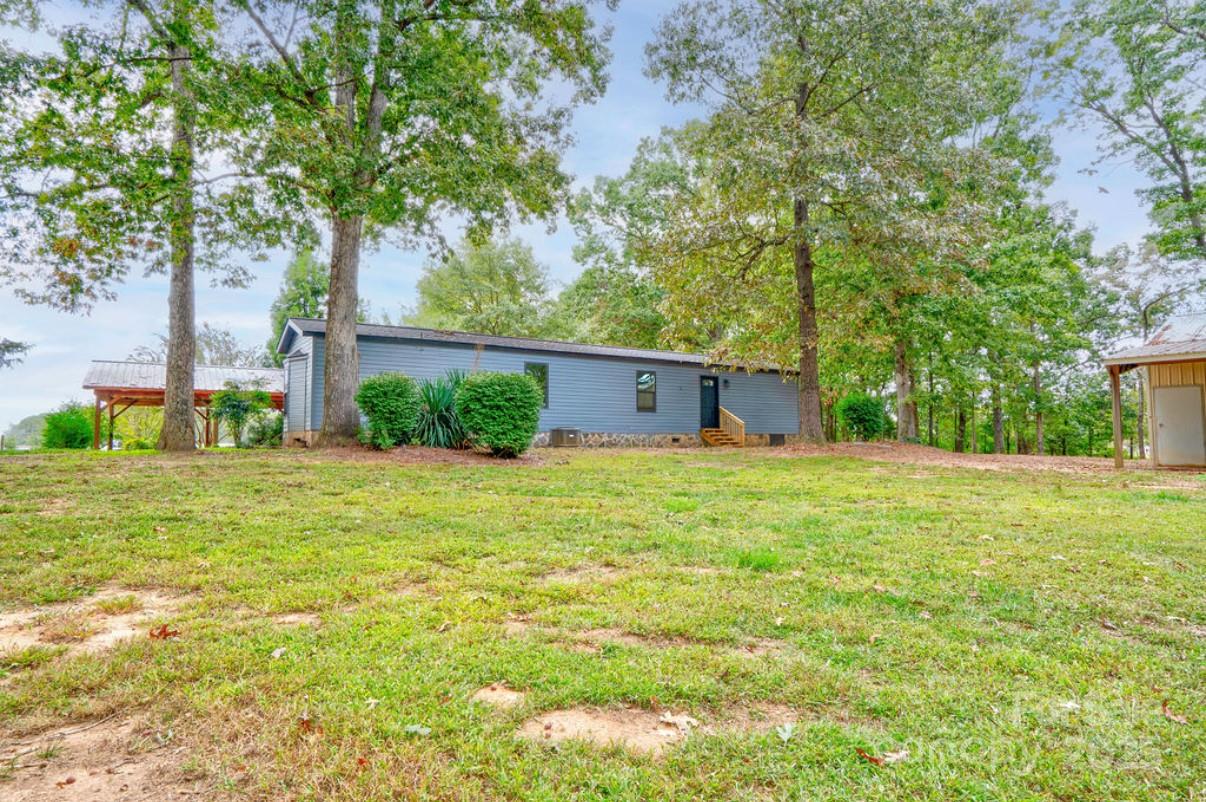 2026 Rehobeth Church Road Shelby, NC 28150 - Photo 10 of 48 a view of a house with backyard and garden
