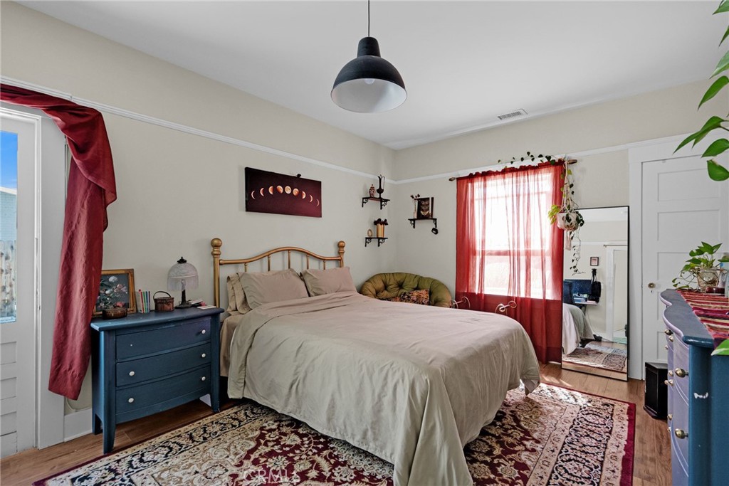 3744 Stoddard Avenue Riverside, CA 92501 - Photo 19 of 29 a bedroom with a bed and a chandelier