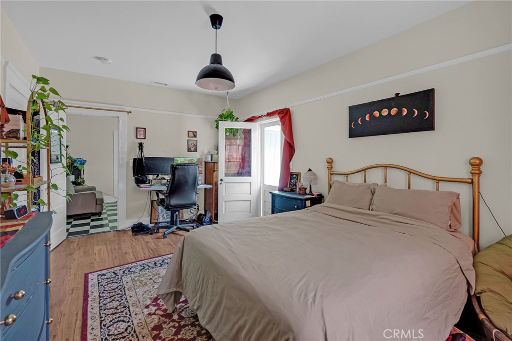 3744 Stoddard Avenue Riverside, CA 92501 - Photo 20 of 29 a bedroom with a bed a mirror and desk