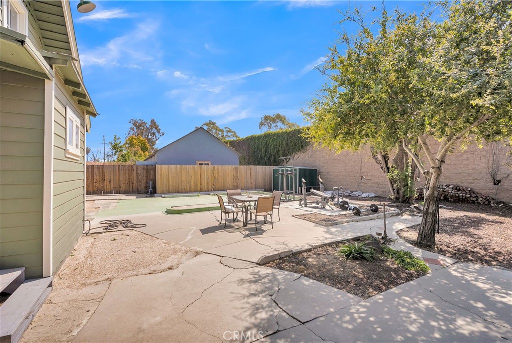 3744 Stoddard Avenue Riverside, CA 92501 - Photo 25 of 29 a view of backyard with table and chairs and wooden fence
