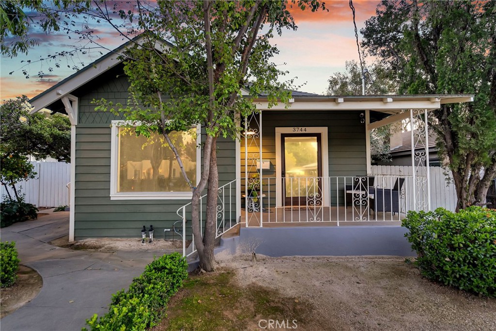 3744 Stoddard Avenue Riverside, CA 92501 - Photo 3 of 29 a view of a porch with a table and chairs under an umbrella