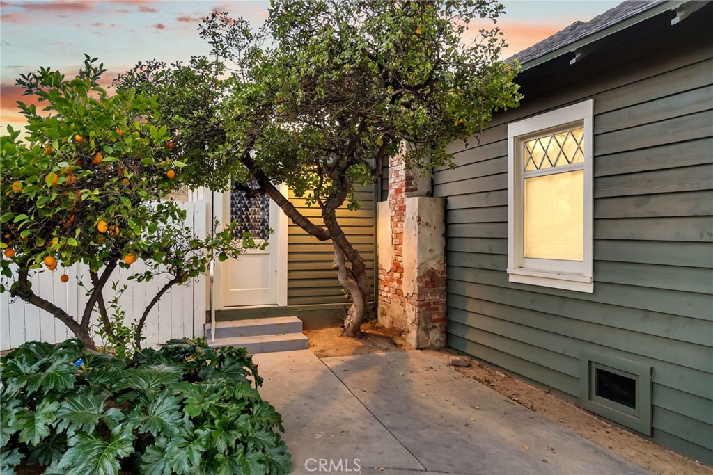 3744 Stoddard Avenue Riverside, CA 92501 - Photo 4 of 29 a backyard of a house with wooden fence and large trees