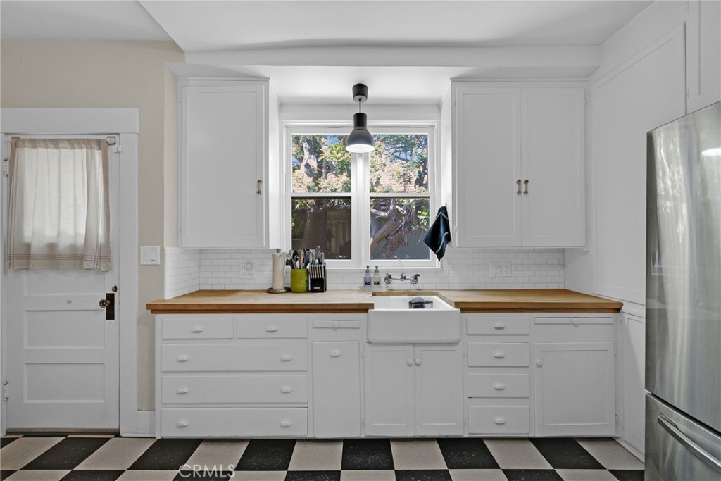 3744 Stoddard Avenue Riverside, CA 92501 - Photo 10 of 29 a kitchen with white cabinets and a window