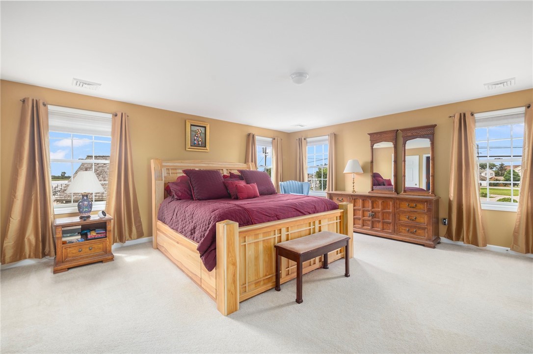 69 East Shore Road Narragansett, RI 02882 - Photo 19 of 42 Huge sunny primary bedroom boasts two double closets, huge ensuite bath and a small peek-a-boo office (behind a pocket door)