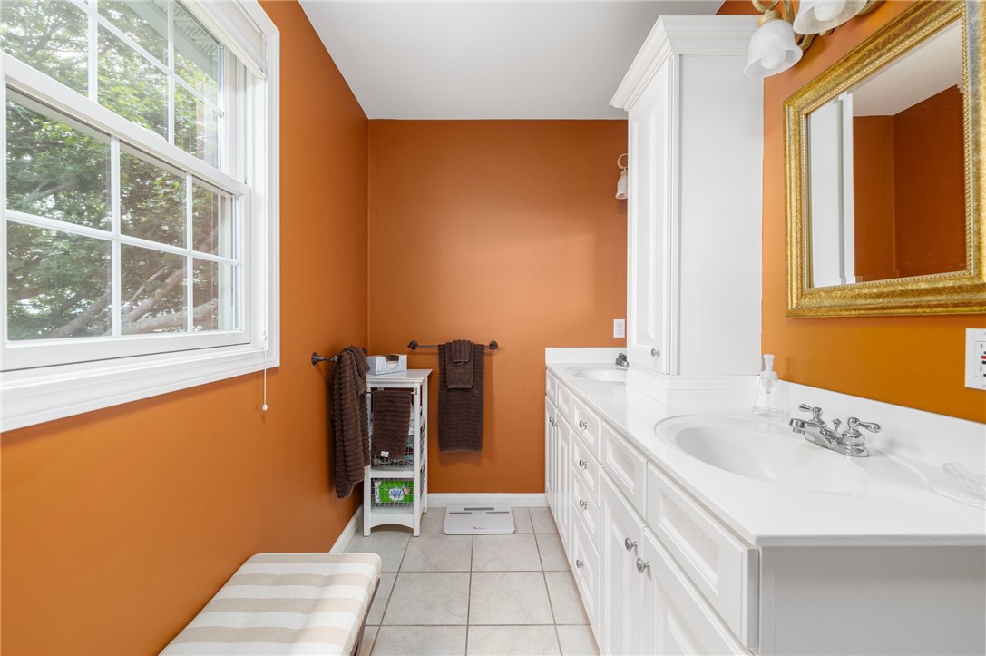 69 East Shore Road Narragansett, RI 02882 - Photo 23 of 42 Beautiful white double vanity provides loads of storage.
