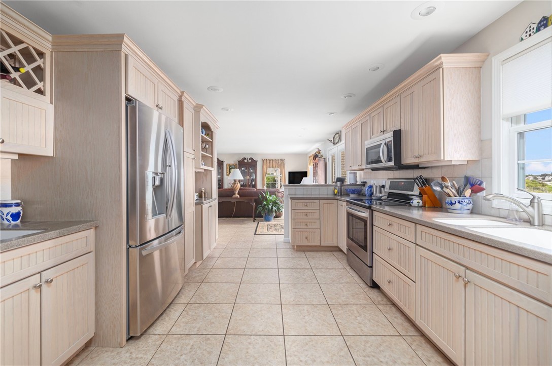 69 East Shore Road Narragansett, RI 02882 - Photo 4 of 42 Another kitchen view from far end of the kitchen. Notice the built in wine rack and bar area.
