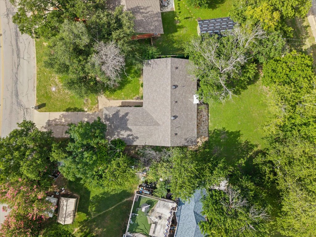 1406 North Georgetown Street Round Rock, TX 78664 - Photo 30 of 34 An aerial perspective reveals a private residential lot with mature trees and a well-maintained yard.