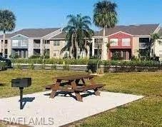 a swimming pool with outdoor seating and yard