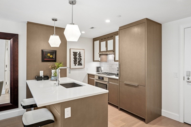 100 Lovejoy Wharf, Unit 5N Boston, MA 02114 - Photo 2 of 23 a kitchen with a dining table and chairs