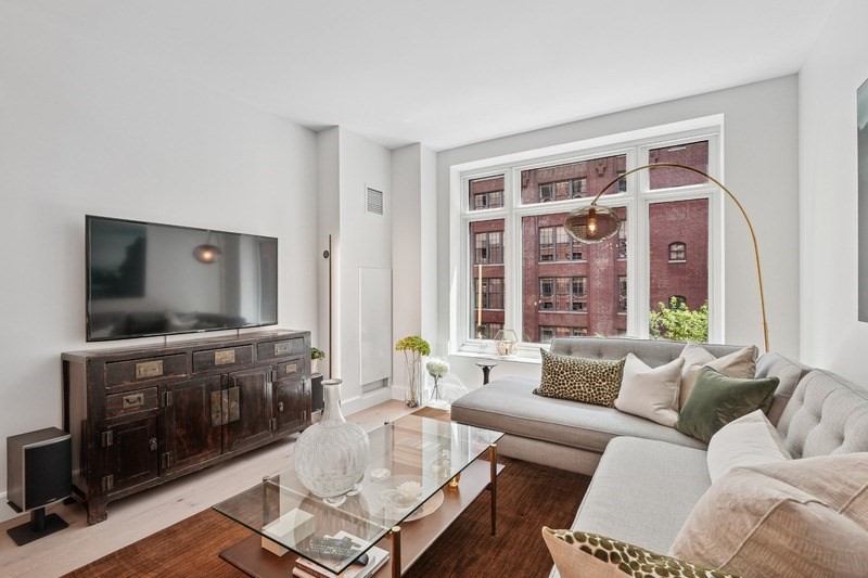 100 Lovejoy Wharf, Unit 5N Boston, MA 02114 - Photo 5 of 23 a living room with furniture and a flat screen tv