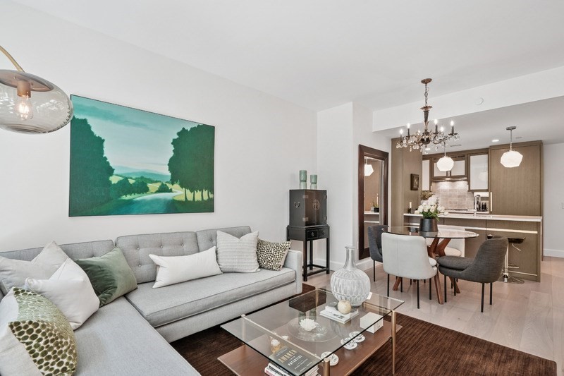 100 Lovejoy Wharf, Unit 5N Boston, MA 02114 - Photo 6 of 23 a living room with furniture a chandelier and a dining table