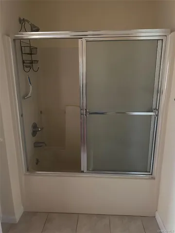 a bathroom with a glass shower door