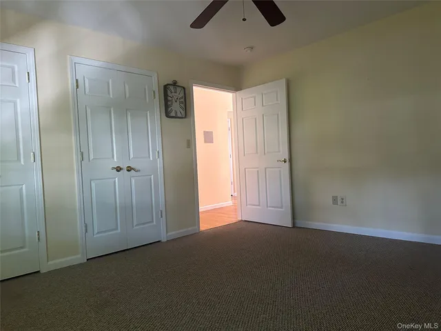 a bedroom with a bed and a mirror on dresser