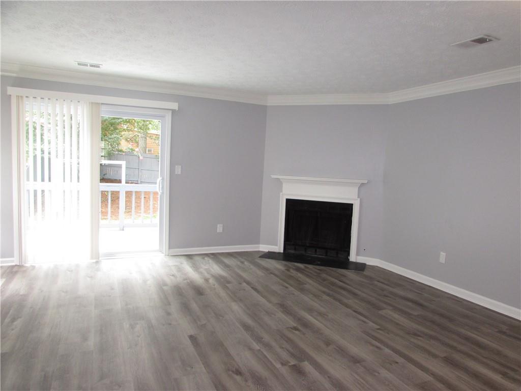 835 Heritage Valley Road Norcross, GA 30093 - Photo 32 of 34 a view of empty room with wooden floor and fireplace