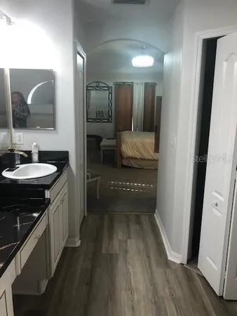 a bathroom with a sink a mirror and a toilet