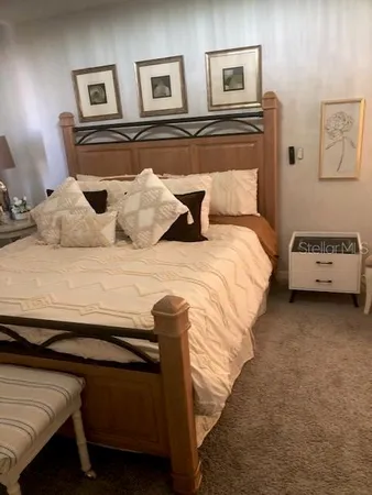 a bedroom with a bed and a night stand